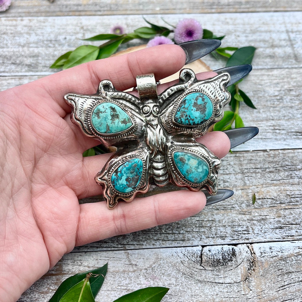 Tibetan Turquoise Butterfly Pendant in hand