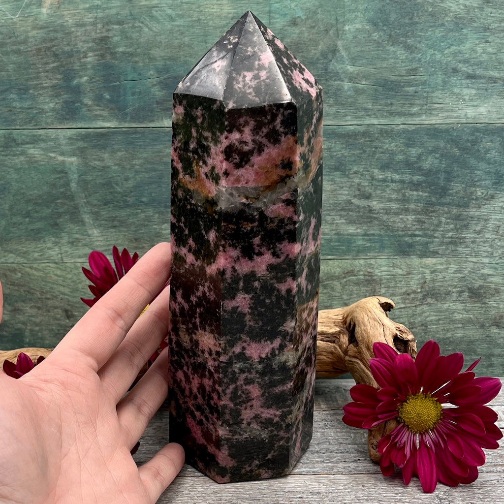 Large Rhodonite Tower Hand shown for scale pink and black 