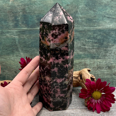 Large Rhodonite Tower Hand shown for scale pink and black 