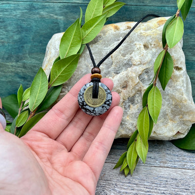 New Horizons Snowflake Obsidian Necklace 30mm hand